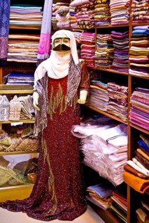 Traditional garments with burqa for Bedouin woman in the souq