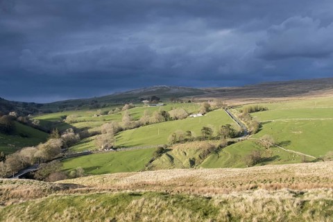 Storm clouds gathering over farmland near Ravenstonedale