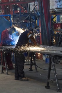 Workers in a factory working with metal on the shop floor