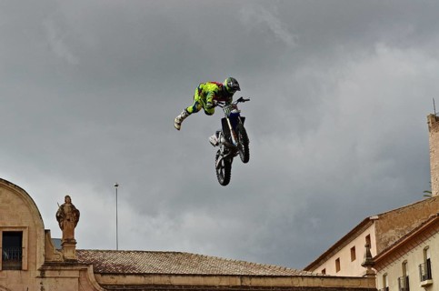 Flying motorbike artist above the rooftops of the old town