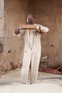 Man sifts flour