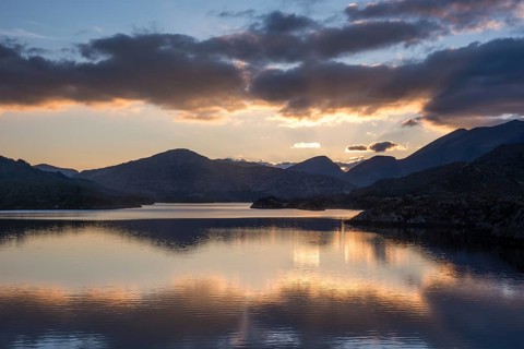 View of lake and mountains at sunset