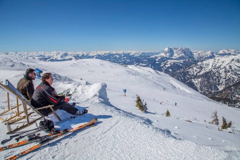 Skiers taking a break in a deck chair
