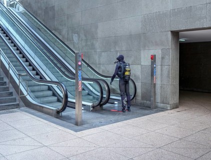 Man in diving suit at the escalator of Potsdamer Platz railway station