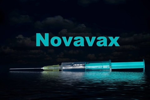 Injection syringe with the vaccine Novavax reflected in the water