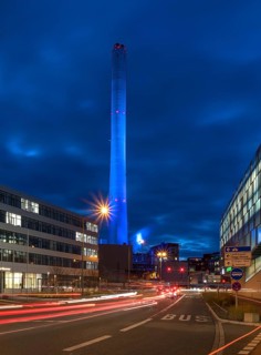 Chimney of the combined heat and power plant illuminated in the evening