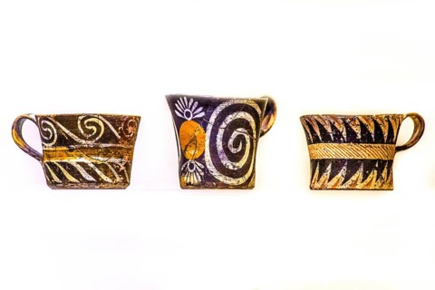 Cups decorated in white and polychrome Kamares style