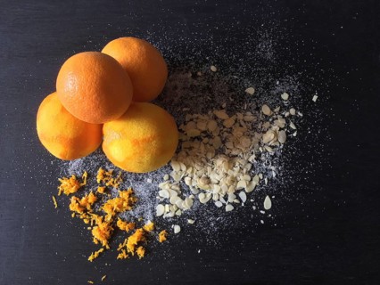 Oranges with abrasion and almond slivers on slate board