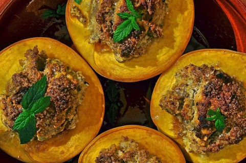 Dessert halved peaches with walnuts and mint leaf