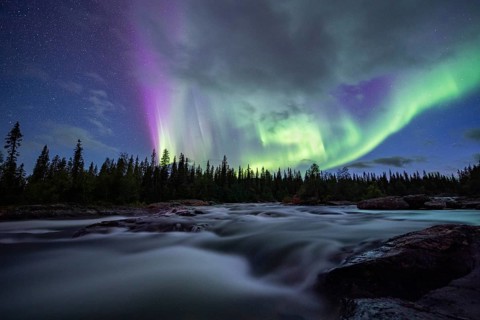 Northern Lights or Aurora Borealis over River Gamajahka or Kamajakka