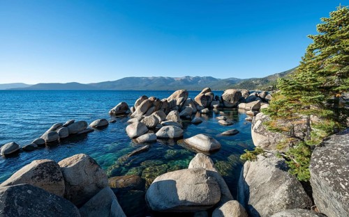 Lake Tahoe shore with round stones in the water