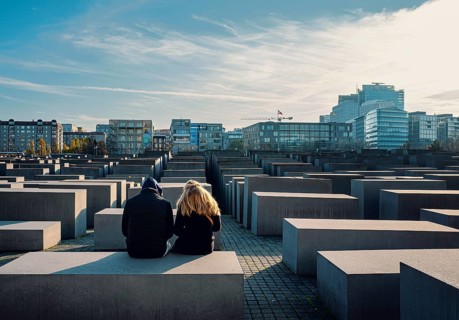 Young couple sitting on a stele of the Holocaust Memorial