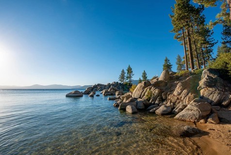 Sand beach and round stones in the water