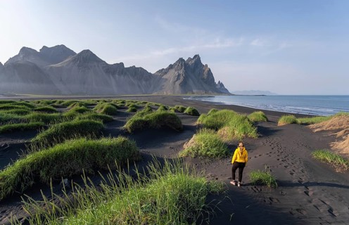 Young woman with rain jacket hiking