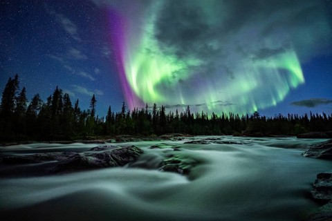 Northern Lights or Aurora Borealis over River Gamajahka or Kamajakka