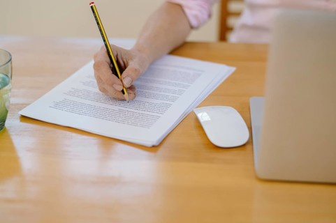 Woman proofreading at her desk