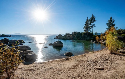 Sand beach and round stones in the water