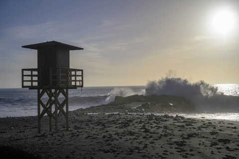 High waves crashing on the beach at a lifeguard lookout