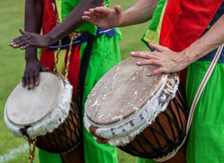 Musicians playing on an African djembe
