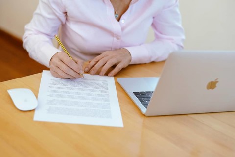 Woman proofreading at her desk