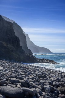 The beach framed by rocks at Playa del Trigo