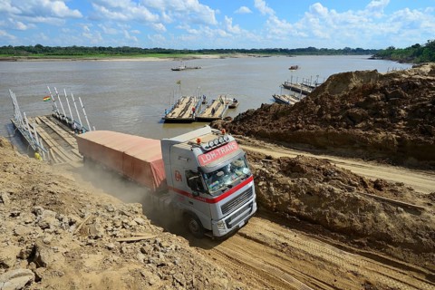 Truck driving off the ferry across the Rio Mamore