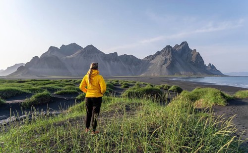 Young woman with rain jacket hiking