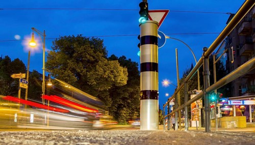 Moving trams at an intersection with a speed camera column