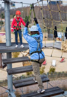 Sporty woman with her niece doing fitness climbing in the outdoor park