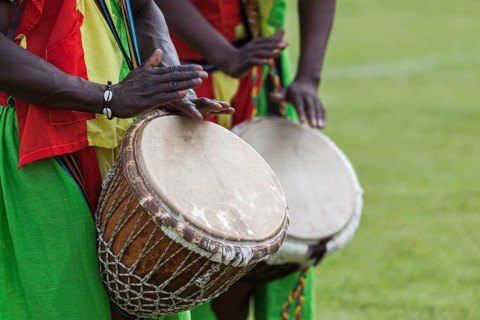 Musicians playing on an African djembe