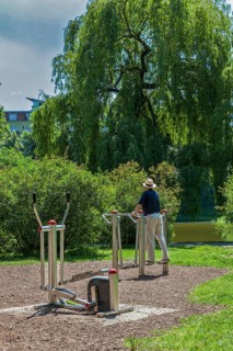 Senior exercising on outdoor fitness equipment at Lietzensee Park