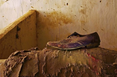 Brown low shoe for men stands on torn jute bag