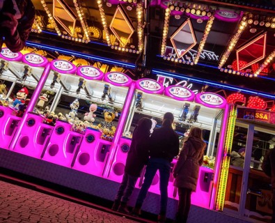 Colourfully illuminated slot machines at a fair