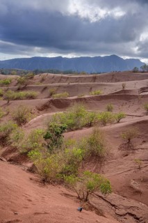 Red earth and sparse vegetation characterise the landscape at Mirador de Abrante