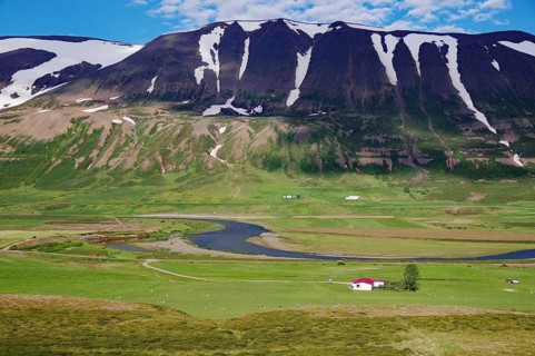 Vast pastures and rugged snow-capped mountains