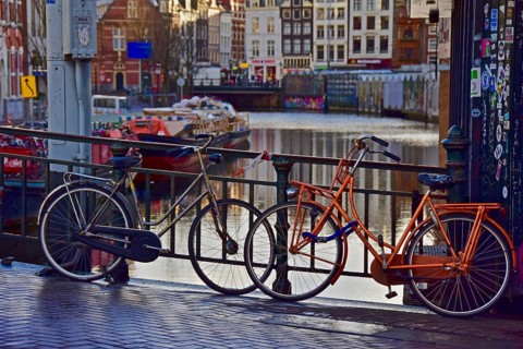 Dutch bicycles on bridge railings of a canal in Amsterdam