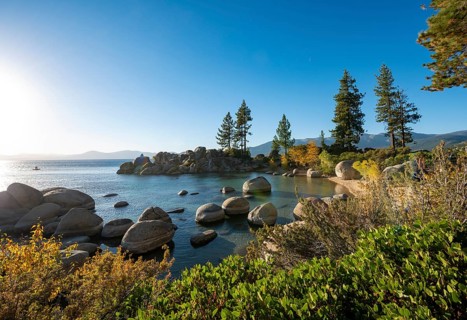 Bay with sandy beach and round stones in the water