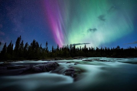 Northern Lights or Aurora Borealis over River Gamajahka or Kamajakka