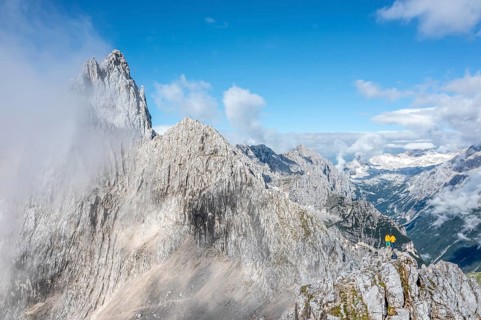 Two hikers in front of alpine panorama