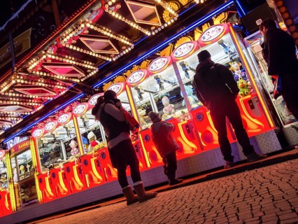 Colourfully illuminated slot machines at a fair