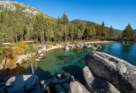 Sand beach and round stones in the water