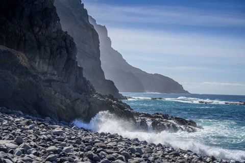 The beach framed by rocks at Playa del Trigo