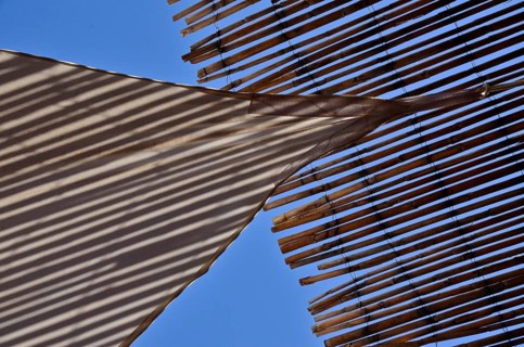 Sun sail meets sun straw mat in the blue sky