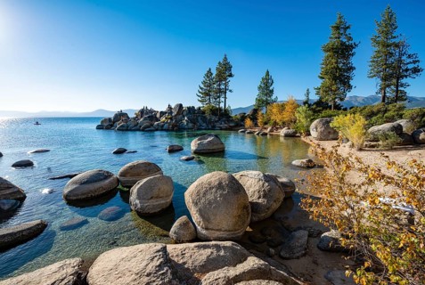 Sand beach and round stones in the water
