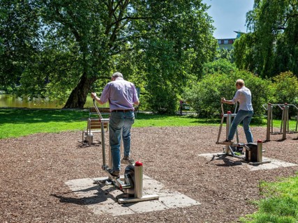 Seniors exercising on outdoor fitness equipment at Lietzensee Park