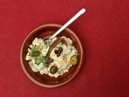 Terracotta dish Russian salad with anchovies