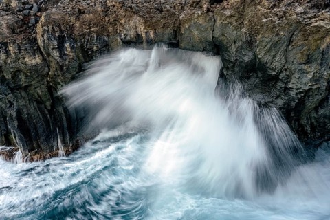 Surf at rocky lava coast
