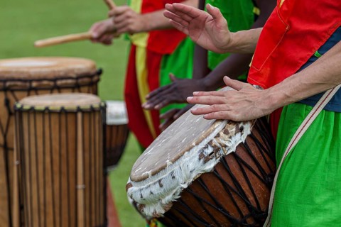 Musicians playing on an African djembe