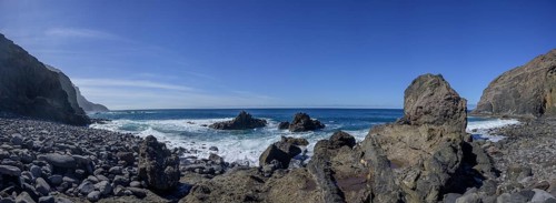 The beach framed by rocks at Playa del Trigo