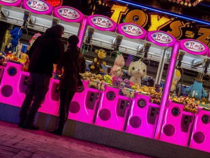 Colourfully illuminated slot machines at a fair